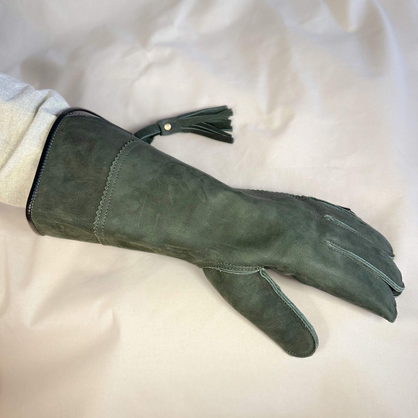 A Forest Green Full-Cuff long falcon gauntlet made with Calf Leather looking at the back of the hand.