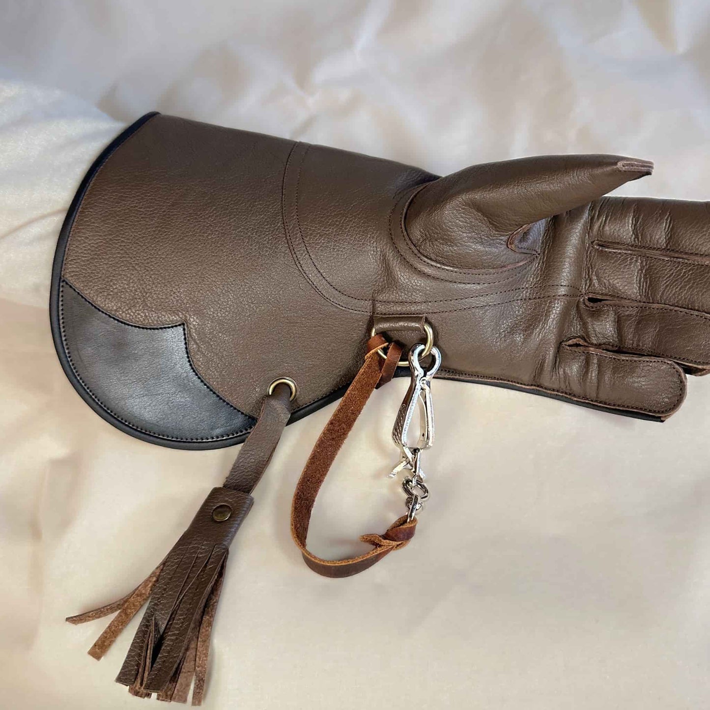 A long Full-Cuff brown falcon gauntlet made with Kangaroo Leather looking at the palm with the (not included but available for purchase) French snap and leather thong.