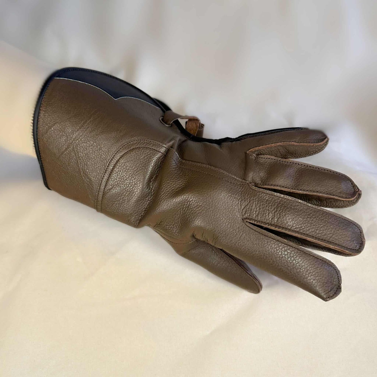 A long Half-Cuff brown falcon gauntlet made with Kangaroo Leather looking at the back of the hand.