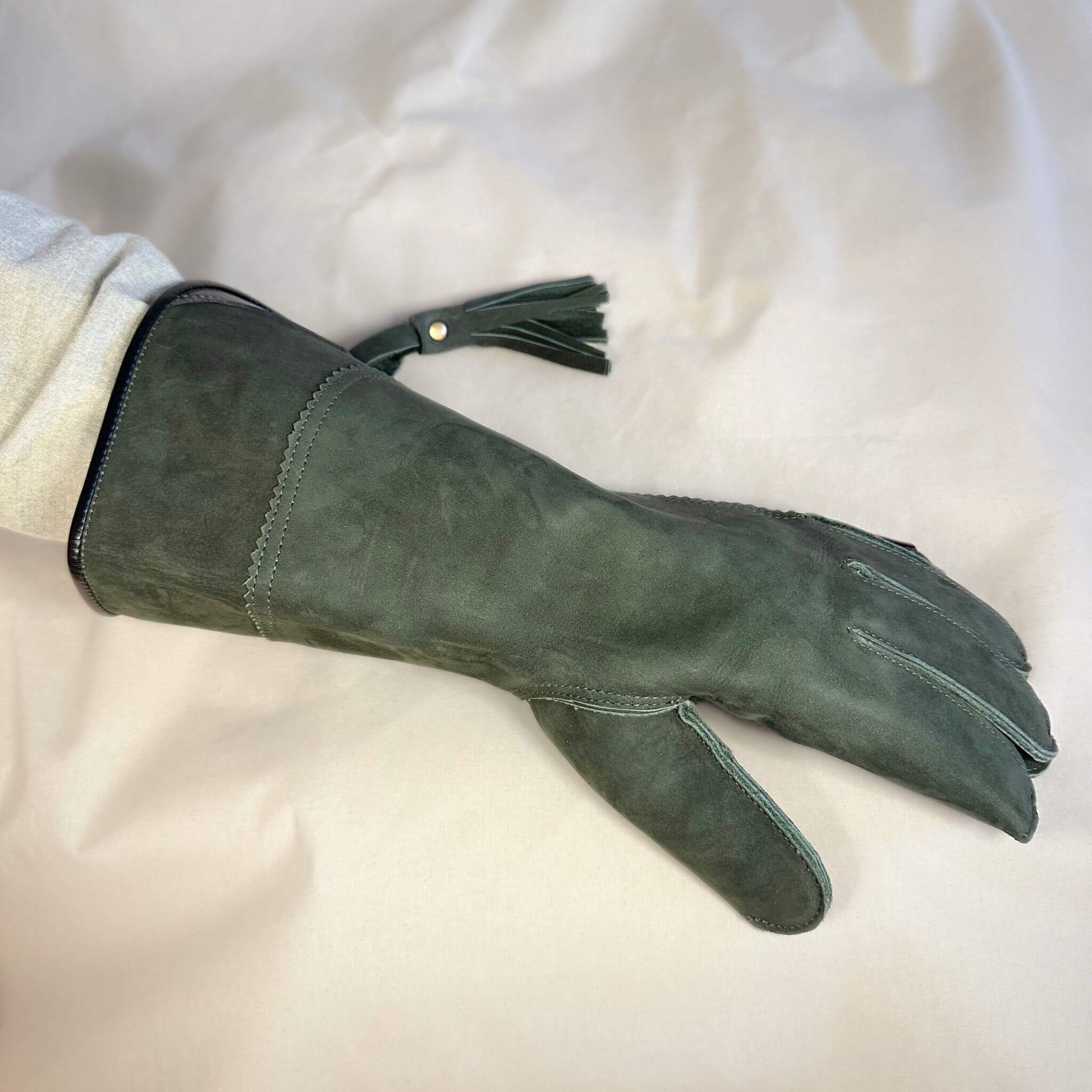 A Forest Green Full-Cuff long falcon gauntlet made with Calf Leather looking at the back of the hand.