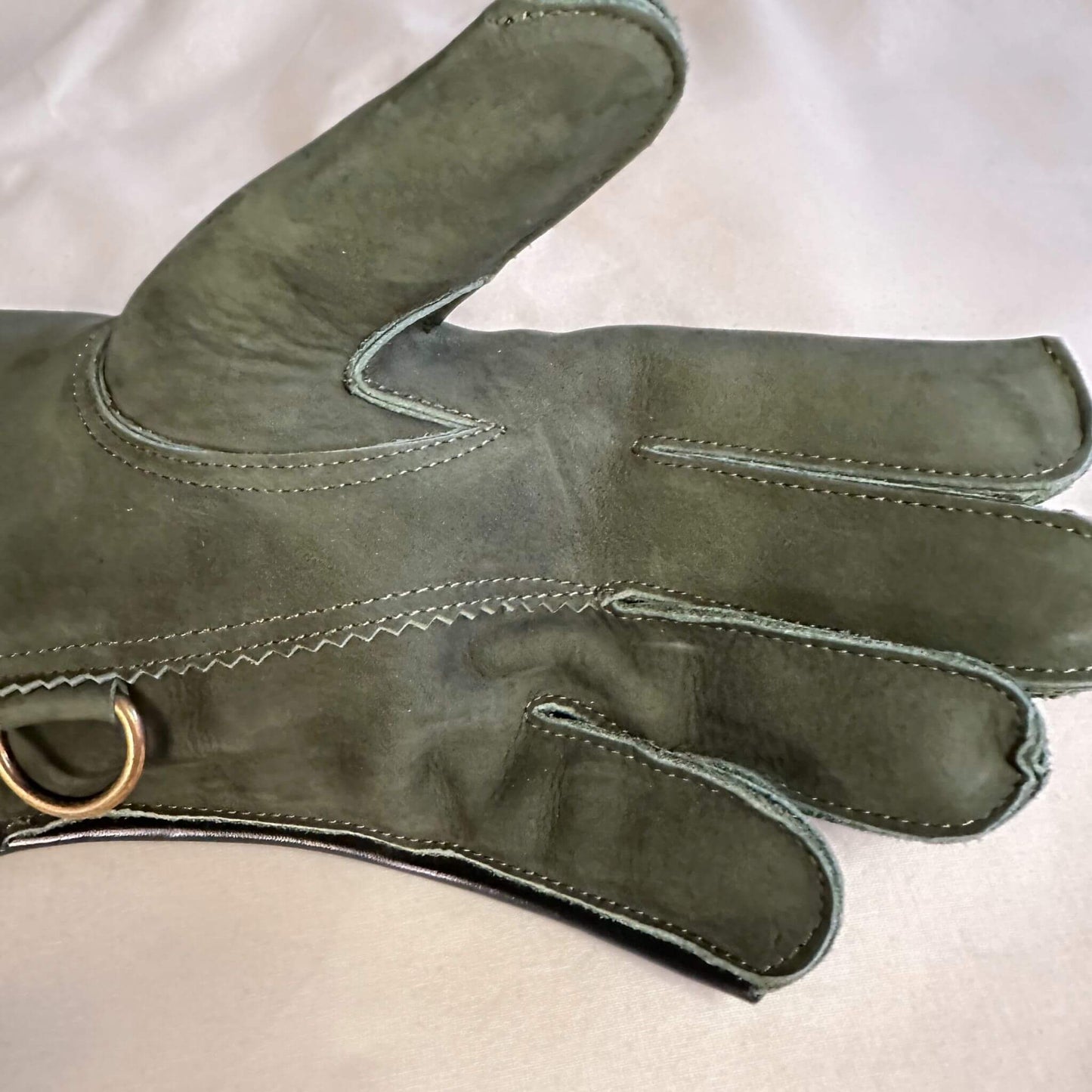 A Forest Green Full-Cuff long falcon gauntlet made with Calf Leather looking at the palm up close.