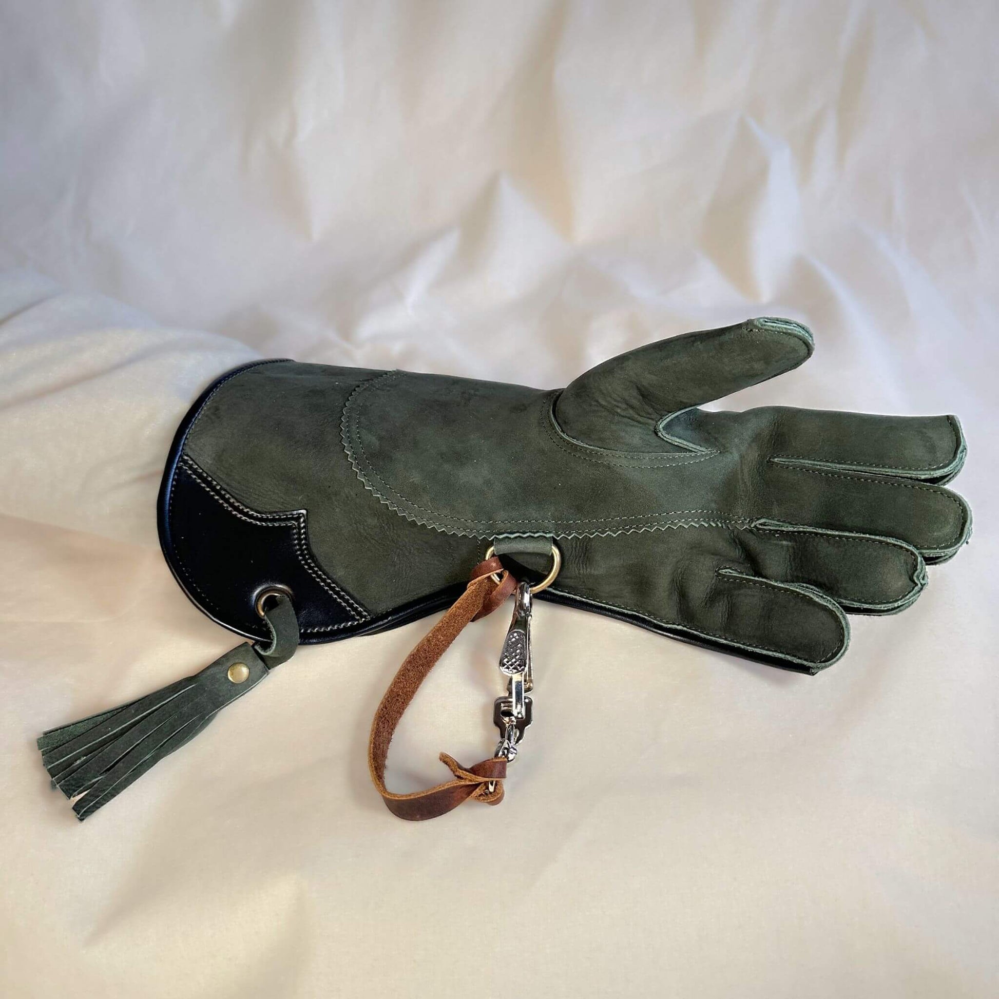 A Forest Green Full-Cuff long falcon gauntlet made with Calf Leather looking at the palm with the (not included but available for purchase) French snap and leather thong.