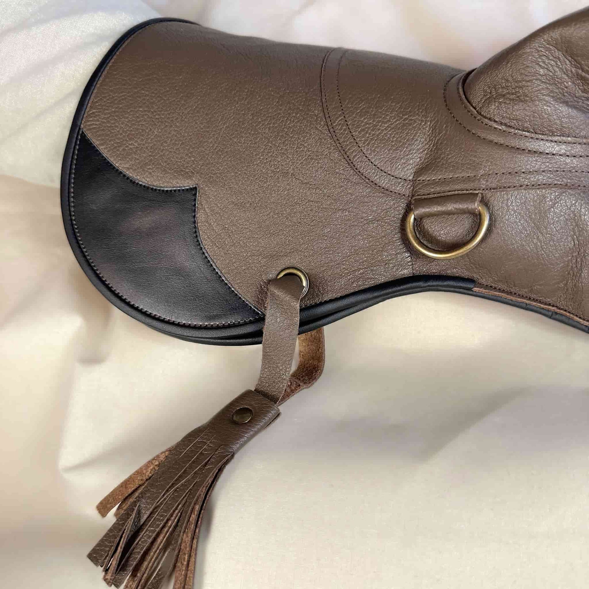 A long Full-Cuff brown falcon gauntlet made with Kangaroo Leather looking at a detailed view of the cuff and tassel.