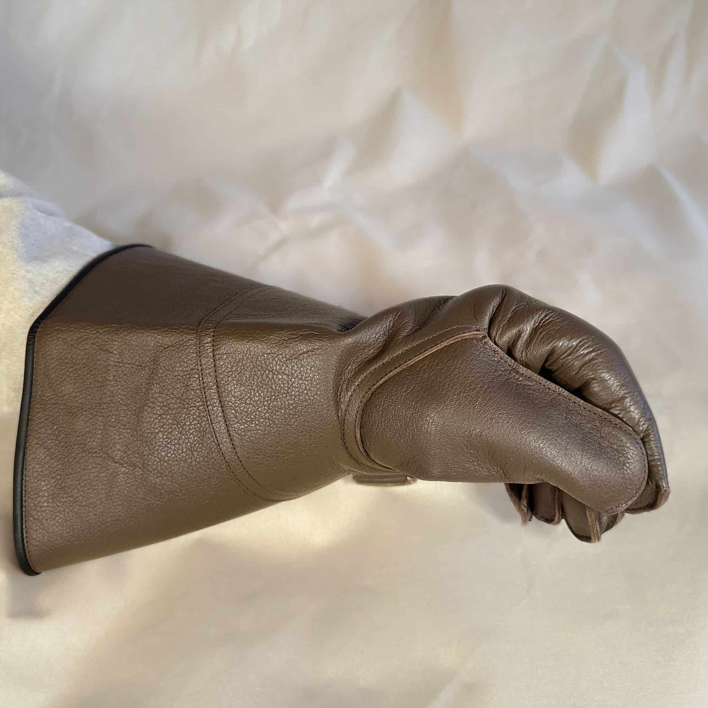A long Full-Cuff brown falcon gauntlet made with Kangaroo Leather looking at the closed fist.