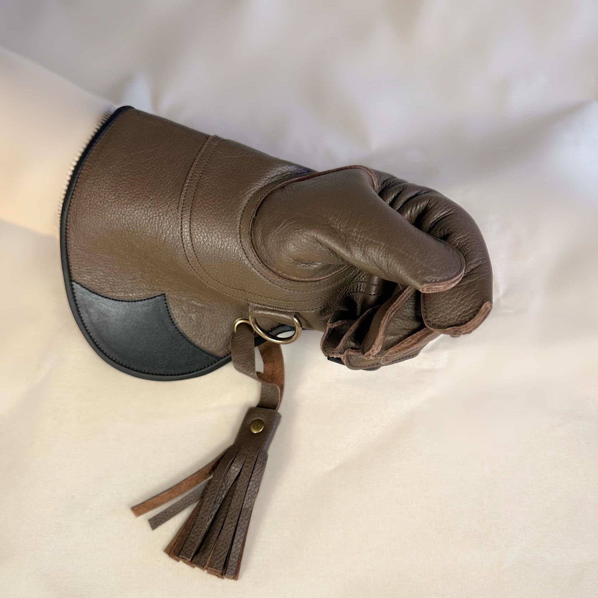 A long Half-Cuff brown falcon gauntlet made with Kangaroo Leather looking at the closed fist.