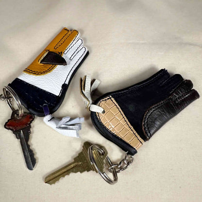 Two miniature sewn gauntlets examples with a key rings.