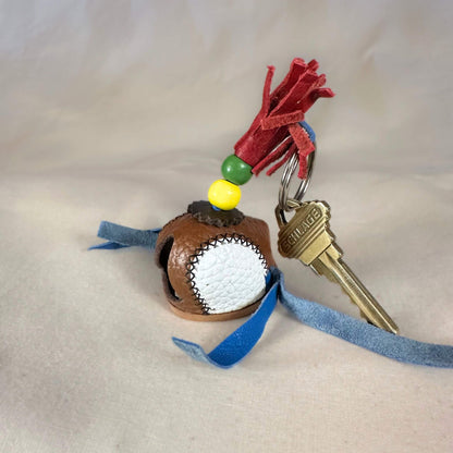 Miniature sewn hood with a key ring from the left side.